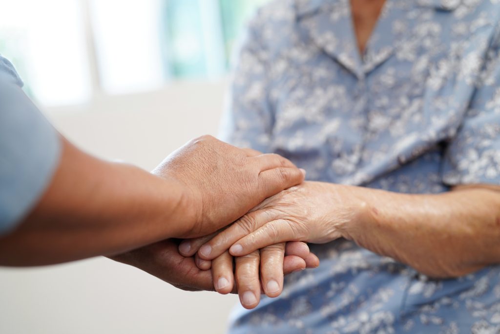 Caregiver holding hands